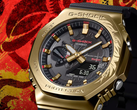 The Casio G-Shock GBM-2100CX-9AJR with an engraved gold bezel, pictured against a stylized red background. (Image source: Casio Japan)