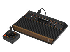 A retro video game console, the Atari 2600, photographed against a plain white background. (Image Source: Evan-Amos on Wikimedia Commons)