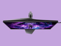The image shows the AOC AG276UZ gaming monitor against a purple background. The gaming monitor features a very gamery design, complete with RGB on its rear.