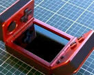 It is unclear who has created this strange clamshell gaming handheld. (Image source: via Nittrx)