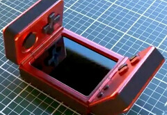 It is unclear who has created this strange clamshell gaming handheld. (Image source: via Nittrx)