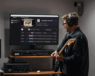 Guitar player plays in front of a monitor showing the app StemKit