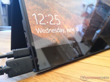 Glossy edge-to-edge glass. Bottom bezel is thick