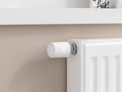 Aqara Radiator Thermostat W600 installed on a white radiator (Image source: Aqara)