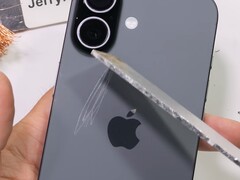 Back of the iPhone 17 being permanently scratched with aluminum. (Image source: JerryRigEverything on YouTube, screenshot)