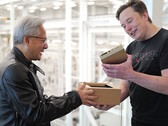 Jensen Huang hands Elon Musk one of the world's first Nvidia DGX Spark compact desktop computers designed for AI model development. (Image source: Nvidia)