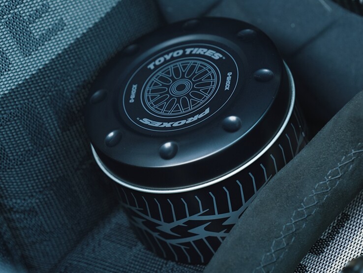 The collaboration includes a custom metal storage tin inspired by a wheel-and-tire setup, complete with Toyo Tires and Proxes branding.