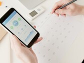 A hand holding a smartphone with the health app open
