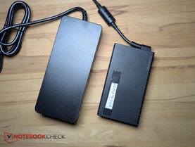 Left: bulky 180 W power adapter. Right: 250 W adapter from the XMG Pro 16