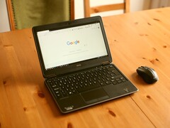 Windows laptop on a wooden table with the Google homepage open in the browser