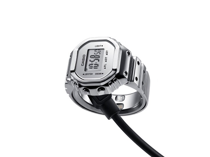 Casio CRW-H001M-8 smart Ring Watch connected to its magnetic USB charging cable.