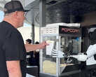 The Optimus robot serving popcorn at the Tesla Diner. (Image source: Tesla Club-SoCal/X)