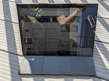 HP EliteBook Folio 13.5 in outdoor use (sun behind the convertible)