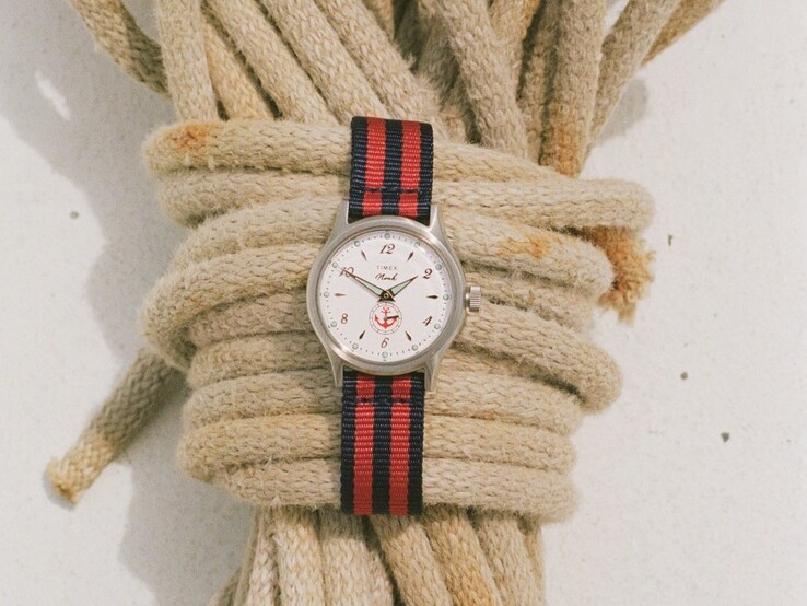 Noah x Timex MK1 Anchor watch with a silver-tone 36mm case, white dial, anchor graphic, and navy-and-red striped fabric strap.