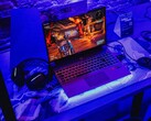 A gaming laptop setup under blue lighting at a demo station, running a game (Image source: Pexels / Bertellifotografia)