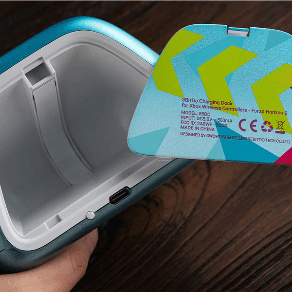 The 8BitDo charging dock has a storage compartment for small accessories for an Xbox controller.