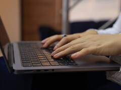 Hands typing on a laptop keyboard