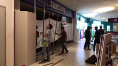 A fire erupted at a Samsung Experience Store in Singapore; workers cordoned off the shop after it was put out. (Source: The Straits Time)