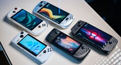 Various handheld gaming PCs on a table