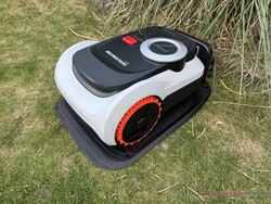 The Navimow i210 LiDAR Pro in its charging station