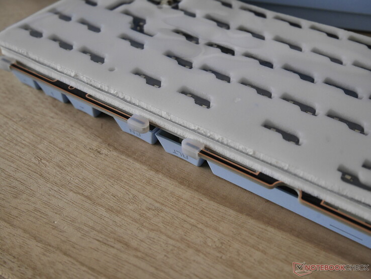 Disassembling the Tide65 reveals very long gasket mount tabs with silicone sock gasket mounts. 