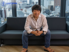 A picture of Hideaki Itsuno sitting on a couch at Tencent LightSpeed Studios (image source: LightSpeed Studios)