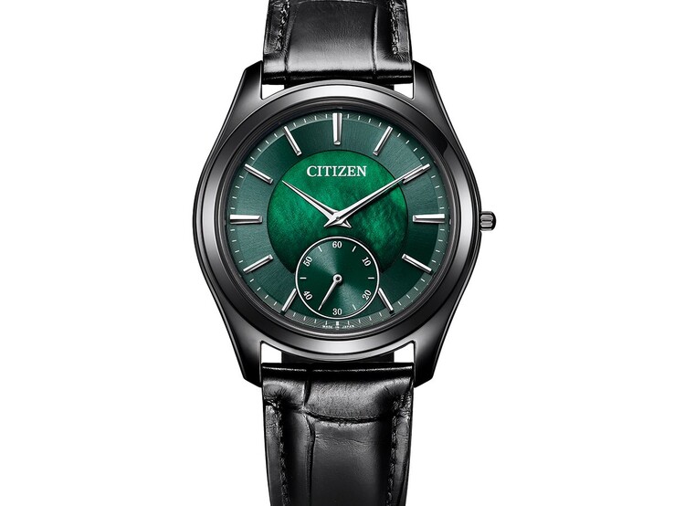 Angled close-up of the Citizen Eco-Drive One AQ5025-04N showing its shimmering green mother-of-pearl dial, silver-tone hands and markers, black case, and leather strap.