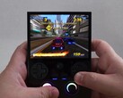 Anbernic RG477V handheld running a racing game during gameplay (Image source: The Phawx via YouTube)
