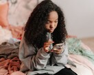 Teenager using a smartphone on a bed, symbolic image for ChatGPT for Teens and parental controls