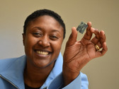 Exec of Intel's Communication and Devices division, Aicha Evans, holds up a modem. (Source: The Motley Fool)