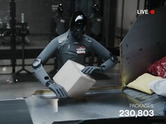 A screenshot from the livestream shows the Figure AI 03 sorting parcels.