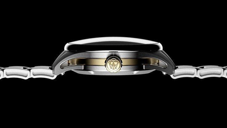 Side profile of the Timex Atelier GMT Première M1a highlighting its curved sapphire crystal, stainless steel case, and gold-tone center section.
