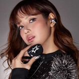 K-pop star LISA wearing the Bose x LISA Ultra Open Earbuds and holding its case. (Image source: Bose)