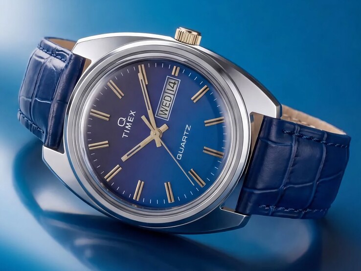 Angled product shot of the Timex Q 1976 Day and Date, highlighting its blue gradient dial, polished stainless-steel case, and gold-tone crown.