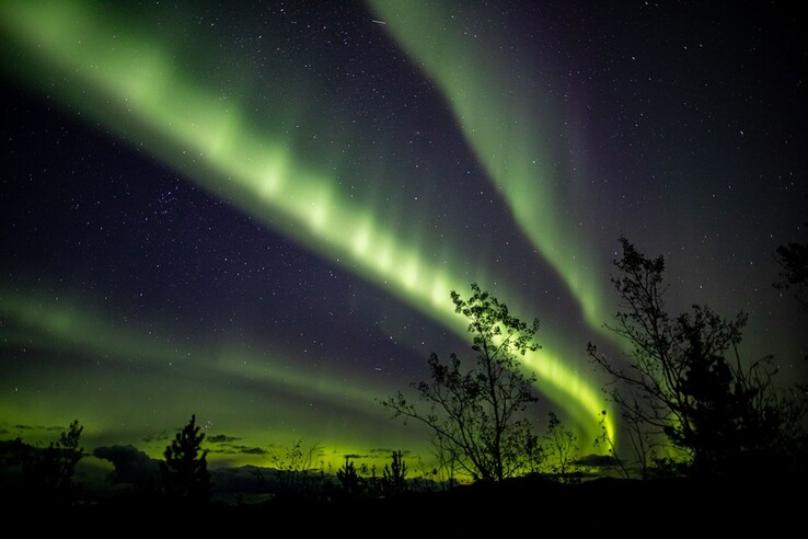 A photo captured in northwestern Canada showing green auroral arcs