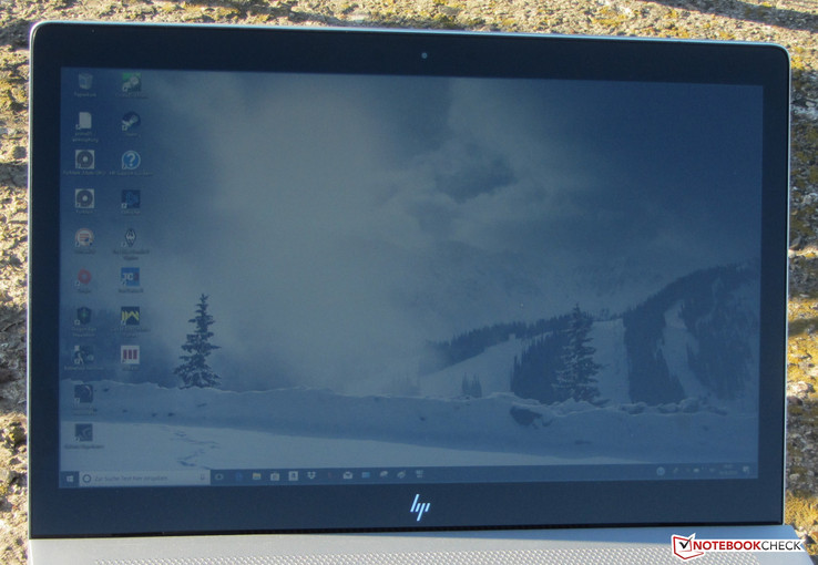 HP Envy outdoors. Photo taken on a sunny day with the sun directly behind the device.