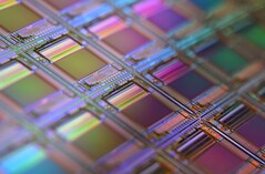 Macro shot of a silicon wafer — structures like these underpin chip designs used in neuromorphic and in-memory computing (Image source: Laura Ockel via Unsplash)