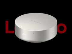 The Lenovo Yoga Mini i mini PC, pictured against a black background and the partially obscured Lenovo logo. (Image source: Lenovo - edited)