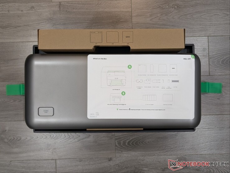 E1 UV Printer in box with setup instructions.