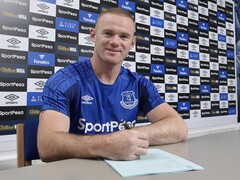 Waryne Rooney signing a document. (Image source: Official Wayne Rooney) 