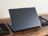 The image shows a photo of the Yoga Slim 7X laptop from behind.