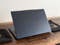 The image shows a photo of the Yoga Slim 7X laptop from behind.