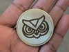 Stock SVG design on brass coin using Fiber laser.