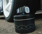 Casio G-Shock DW5600TT25-1 x Toyo Tires watch displayed on a tire-themed metal tin next to a car wheel.