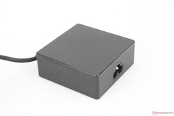 The universal USB-C AC adapter is relatively small (~7.5 x 7.5 x 2.9 cm) considering its 90 W output