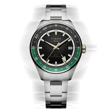 The dial is black enamel with gold hands and markers, ringed by a diamond-cut black and green 24-hour track.