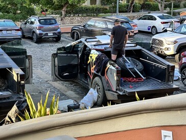 The Cybertruck crew appears to be fiddling with a burly looking roof rack mounted to the rear section of the roof. (Image source: The Autopian)