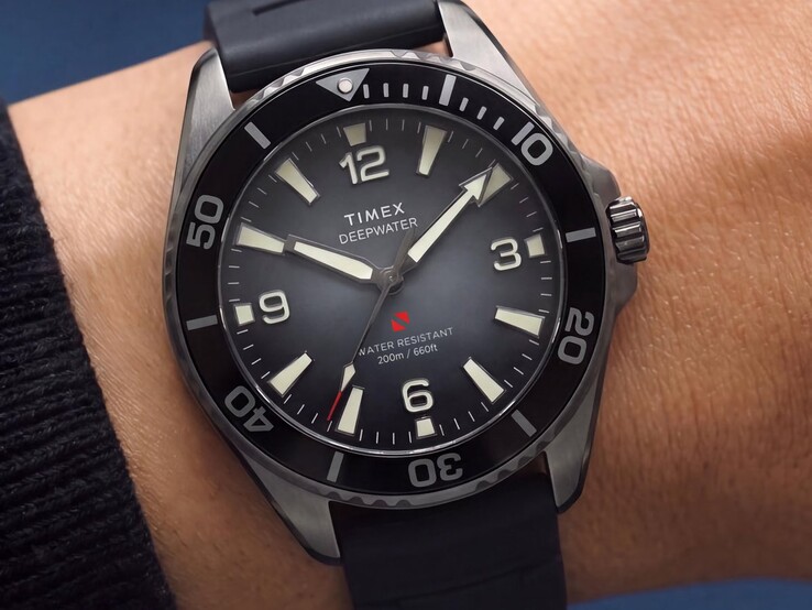 Timex Deepwater Arctic 200 dive watch with a smoky dégradé dial, black ceramic bezel, luminous hour markers, and black rubber strap, shown on a wrist.