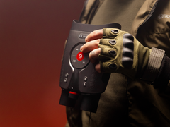 The DVX Night Storm X3, pictured in the hands of a person wearing outdoor gloves and gear against a red background. (Image source: DVX)