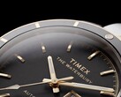 Close-up of the black-dial Timex Waterbury Heritage Automatic showing its faceted luminous hands, hour markers, day-date display, and black bezel.